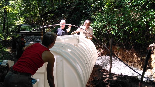 Getting the tank into the hole.